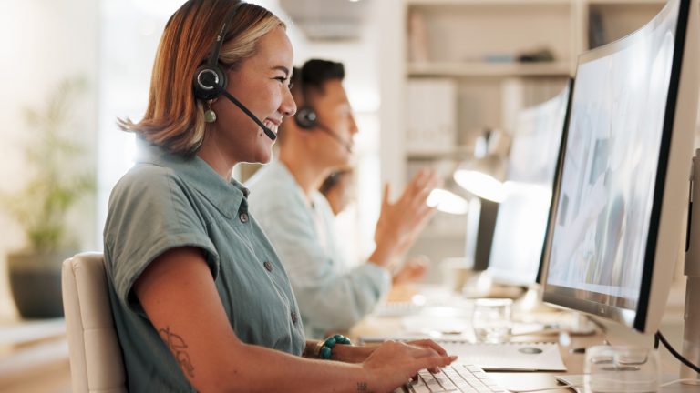 Woman at a computer wearing a headset providing customer service