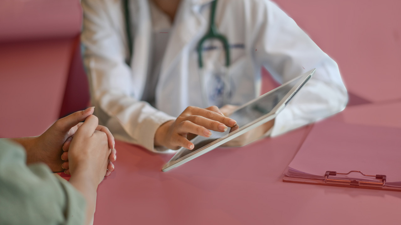 Healthcare professional interacting with a patient support program on their tablet